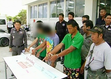 The three drug suspects point to a table of their confiscated possessions at Banglamung police station on Feb. 22.